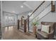 Welcoming foyer showcasing a staircase with wood trim and a decorative chair at 235 E 11Th St, Indianapolis, IN 46202