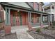 A welcoming front porch adorned with brick columns and a cozy seating area. Number 235 clearly displayed at 235 E 11Th St, Indianapolis, IN 46202