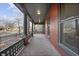 Spacious front porch featuring classic columns and elegant railings. A serene space for outdoor enjoyment and relaxation at 235 E 11Th St, Indianapolis, IN 46202