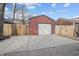 View of detached garage with a concrete pad and wooden fence at 235 E 11Th St, Indianapolis, IN 46202