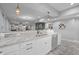 A kitchen counter overlooks a living area with neutral paint, decorative lighting, and stainless steel appliances at 235 E 11Th St, Indianapolis, IN 46202