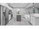 Bright kitchen features stainless steel appliances, white cabinets, a gray island, and decorative tile floors at 235 E 11Th St, Indianapolis, IN 46202