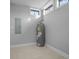 Utility room with water heater and electrical panel, featuring tiled floors at 235 E 11Th St, Indianapolis, IN 46202