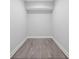 Walk-in closet with hardwood floors and recessed lighting, ready for organization at 235 E 11Th St, Indianapolis, IN 46202