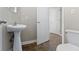 Compact bathroom featuring a pedestal sink and a tiled floor at 2605 Carrollton Ave, Indianapolis, IN 46205