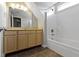Well-lit bathroom has a tub and a large mirror at 2605 Carrollton Ave, Indianapolis, IN 46205