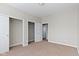 Neutral bedroom featuring beige walls, a carpeted floor, and closet space at 2605 Carrollton Ave, Indianapolis, IN 46205