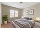 Bedroom with a large window, a queen bed with gray linens, and decorative wall art at 2605 Carrollton Ave, Indianapolis, IN 46205
