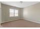 Neutral bedroom with a large window and beige carpet at 2605 Carrollton Ave, Indianapolis, IN 46205