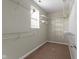 Walk-in closet boasts carpeted floors and plenty of shelving at 2605 Carrollton Ave, Indianapolis, IN 46205