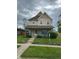 Charming two-story home with a welcoming porch and well-manicured lawn at 2605 Carrollton Ave, Indianapolis, IN 46205