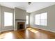 An empty living room featuring hardwood floors, a fireplace, and natural light at 2605 Carrollton Ave, Indianapolis, IN 46205