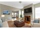 Staged living room featuring hardwood floors, a fireplace, and natural light at 2605 Carrollton Ave, Indianapolis, IN 46205