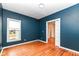 Bedroom with hardwood floors, large window and blue painted walls at 2914 N Delaware N St, Indianapolis, IN 46205