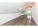 Finished bonus room featuring wood floors, skylights, and built-in storage at 2914 N Delaware N St, Indianapolis, IN 46205