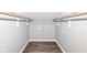 Walk in closet featuring wood floor and gray walls with storage shelving at 2914 N Delaware N St, Indianapolis, IN 46205