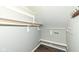 Walk-in closet features a shelf with railing, wooden floor, and a hook for hanging coats or other items at 2914 N Delaware N St, Indianapolis, IN 46205