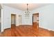 Bright dining room featuring hardwood floors, built-in shelving, and elegant chandelier lighting at 2914 N Delaware N St, Indianapolis, IN 46205