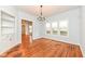 Spacious dining room with hardwood floors, a chandelier, and an abundance of natural light from large windows at 2914 N Delaware N St, Indianapolis, IN 46205