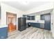 Modern kitchen featuring stainless steel appliances, white backsplash, and blue cabinets at 2914 N Delaware N St, Indianapolis, IN 46205