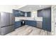 Stylish kitchen with gray floors, stainless steel appliances, and blue cabinets at 2914 N Delaware N St, Indianapolis, IN 46205