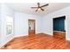 Bright living room with hardwood floors, a ceiling fan, and multiple doorways leading to other areas of the home at 2914 N Delaware N St, Indianapolis, IN 46205