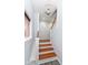 Staircase with hardwood stairs and white banister under a modern light fixture at 2914 N Delaware N St, Indianapolis, IN 46205