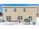 Back exterior of a two-story home showing windows, doors, and snow covered yard at 5303 Brandywine Dr, Whitestown, IN 46075