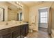 Bathroom featuring double vanity sinks and tiled shower with natural light at 5303 Brandywine Dr, Whitestown, IN 46075