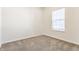Bright, carpeted bedroom with a large window offering plenty of natural light at 5303 Brandywine Dr, Whitestown, IN 46075