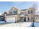 Attractive two-story home featuring brick and vinyl siding, complemented by a well-manicured front yard in winter at 5303 Brandywine Dr, Whitestown, IN 46075