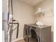 Laundry room featuring a modern washer and dryer set with a shelf, laundry supplies, and towels at 5303 Brandywine Dr, Whitestown, IN 46075