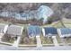 Aerial view of a neighborhood featuring a brick home with a long driveway and mature trees at 5815 Noble Dr, Indianapolis, IN 46234