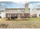 A brick house with a wooden deck, a grill, and outdoor furniture in the backyard at 5815 Noble Dr, Indianapolis, IN 46234