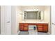 Bathroom with a large vanity featuring double sinks, lighting, and a door leading to another room at 5815 Noble Dr, Indianapolis, IN 46234