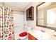Bright bathroom with a shower and tub combo, dark cabinets, and a large mirror at 5815 Noble Dr, Indianapolis, IN 46234