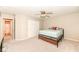 Carpeted bedroom with a double door closet featuring light walls, and a ceiling fan at 5815 Noble Dr, Indianapolis, IN 46234