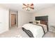 Bedroom featuring neutral carpet and paint, a ceiling fan, and a door leading to another room at 5815 Noble Dr, Indianapolis, IN 46234