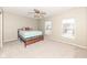 Bright bedroom features neutral carpet, a ceiling fan, and great natural light from two windows at 5815 Noble Dr, Indianapolis, IN 46234