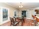 Eat-in dining area features a glass-top dining table and sliding barn doors at 5815 Noble Dr, Indianapolis, IN 46234