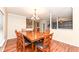 The formal dining room features a large wooden table and chair set and hardwood floors at 5815 Noble Dr, Indianapolis, IN 46234