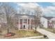 A stately brick home with white columns, mature trees, and manicured lawn at 5815 Noble Dr, Indianapolis, IN 46234