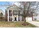 Stunning two-story brick home features a large, covered front porch with stately white columns at 5815 Noble Dr, Indianapolis, IN 46234