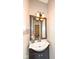Traditional half-bath features a bowl sink and decorative mirror at 5815 Noble Dr, Indianapolis, IN 46234