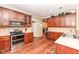 Kitchen boasts stainless steel appliances, ample counter space, and warm wood cabinetry at 5815 Noble Dr, Indianapolis, IN 46234