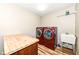 Laundry room featuring brand new washer and dryer, utility sink, and vinyl flooring at 5815 Noble Dr, Indianapolis, IN 46234