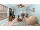 Relaxing living room with cozy furniture, ceiling fan, and large windows with wooded view at 5815 Noble Dr, Indianapolis, IN 46234