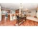 Open floor plan with view of kitchen featuring hardwood floors, and fireplace in the living room at 5815 Noble Dr, Indianapolis, IN 46234