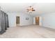 Neutral main bedroom with vaulted ceiling and light-colored carpet and walls, and doors leading to other rooms at 5815 Noble Dr, Indianapolis, IN 46234