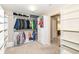 Large walk-in closet featuring custom shelving, closet rods, and additional space, and a door to another room at 5815 Noble Dr, Indianapolis, IN 46234